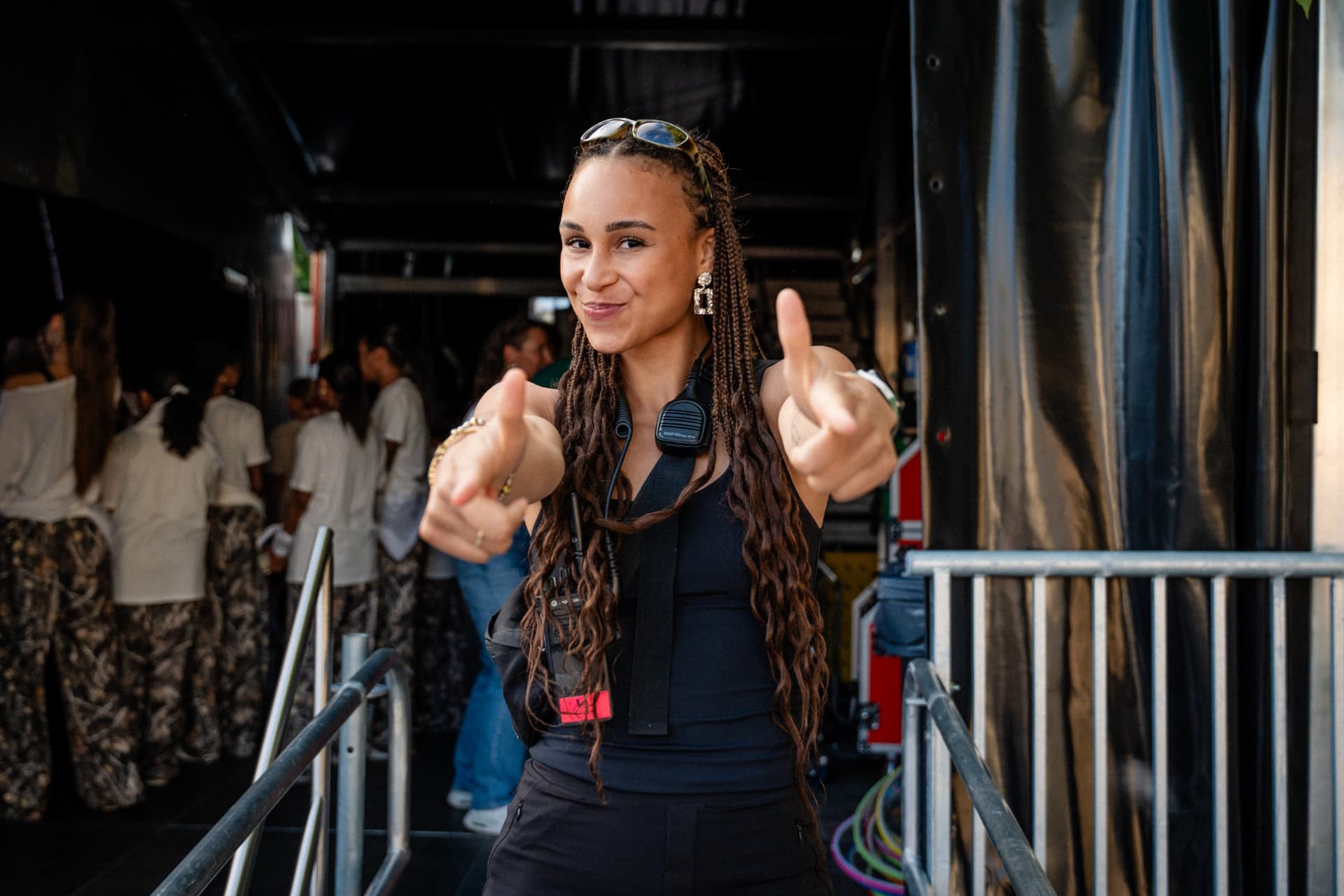 Noreena McCleave backstage at an event, smiling and giving two thumbs up
